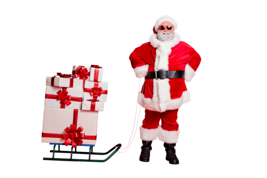 Full length photo of cheerful santa claus in eyewear eyeglasses having sledge carry presents for christmas night isolated over red background