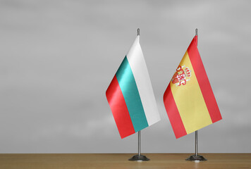 Table flags of Spain and Bulgaria on a gray blurred background