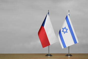 Table flags of Israel and Czech Republic on grey blurred background