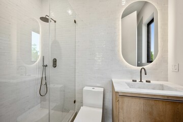 Modern bathroom with glass shower and wooden vanity