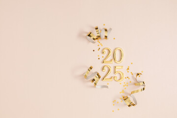 Golden numbers 2025. Happy New Year! Golden holiday decorations, streamers. Light pastel table background. Top view, flat lay. Space for text.