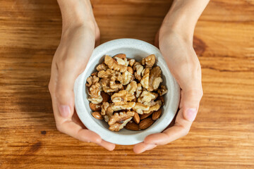 Healthy organic mixed nuts protein snack natural nutrition wellness lifestyle fresh superfood bowl hands