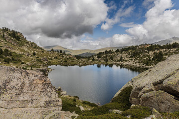 Fototapeta premium Estany del Cap dels Pessons, lake de Pessons in the Pyrenees mountains of Andorra, summertime