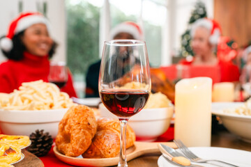 Joyful Christmas Dinner Celebration, Family Friends Gather Around the Table Meal, Enjoying Delicious Food and Drinks in Beautifully Decorated Home, Creating Happy Memories During Holiday Event