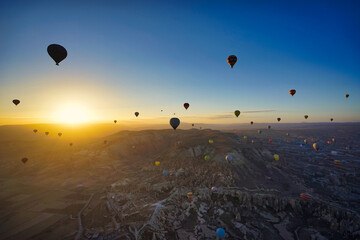 Hot Air Balloons at Sunrise Over Cappadocia landscape