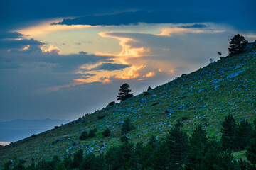 Sunset behind clouds over the Croatian Adriatic coast.