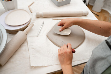 Creating perfect homogenous consistence for ceramics handcraft. Wedging the clay to eliminate air bubbles.