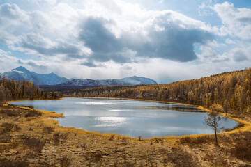 Top view of lake Kidelyu against the background of snow-capped peaks of the Kurai range. Ulagansky District, Altai Republic, Russia