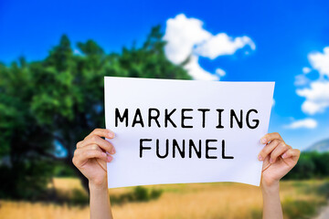 Marketing funnel message written on white paper with nature background. Conceptual marketing funnel...