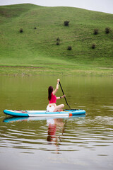 Woman with paddle board, sporty lifestyle.