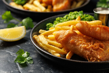 British Fish and chips with mashed peas, tartar and ketchup sauce.