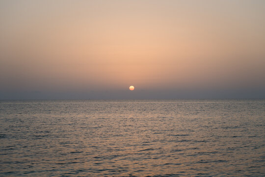 sunset over the sea in blue, orange and yellow colors
