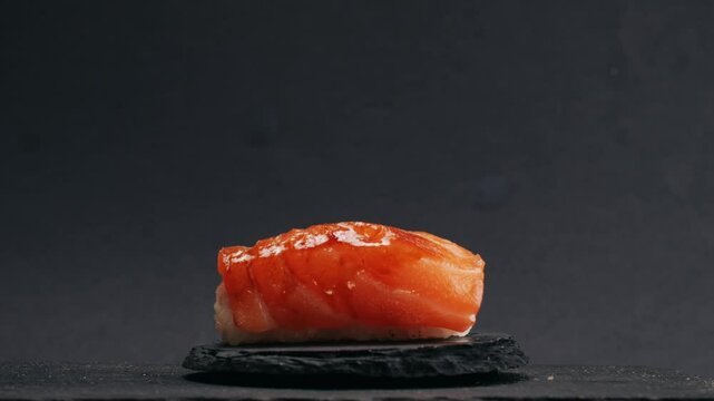 Chef cooking Sashimi Nigiri Platter with flambe fire, japanese sushi restaurant, Fresh Tuna and Salmon Slices in modern cafe, traditional food, raw red fish dish, omega 3.