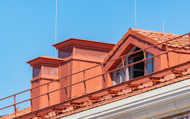House with a pipe  and attic window on a roof