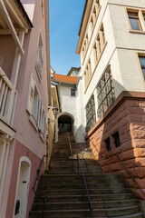 narrow street with a white building and a red roof