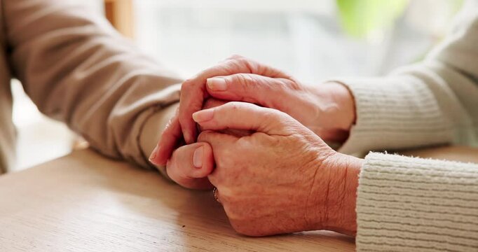 Holding hands, connection and senior couple by table for love, empathy or forgiveness in marriage. Unity, home and elderly man and woman with support for trust, loyalty and care for bonding together.