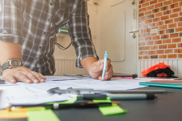 architect prepares blueprints for engineers to check blueprints before construction and calculate construction costs correctly. joint blueprint review between architects and construction engineers.