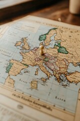 Fototapeta premium Exploration of europe: pushpin on vintage map highlighting travel adventures