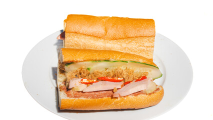 Banh mi thit, Vietnamese cuisine. Bread are wet with cheese, pate. Topped with ham, cold cuts, shredded pork, cucumber slices, cilantros, red pepper, pickles.Soy sauce or salt, pepper enriches flavour