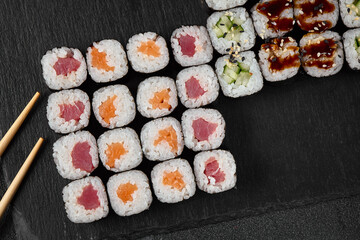 Top-Down View of Assorted Hosomaki Sushi Rolls on Slate Platter with Natural Lighting