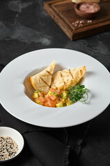 Gourmet Salmon Tartare and Avocado with Ciabatta Toasts on Rustic Black Background