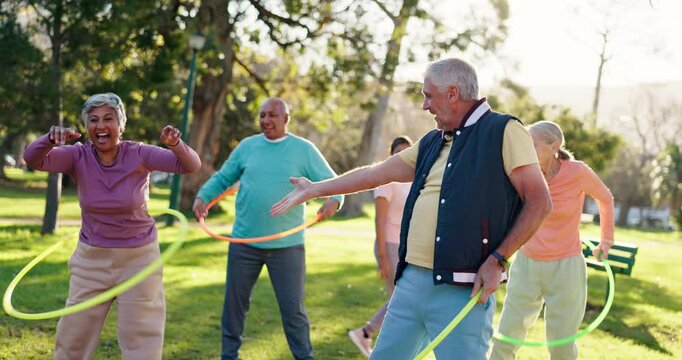 Senior people, exercise and nature with hoop for class, fun workout or elderly care in fitness. Happy or mature group talking with toy for movement, balance or funny activity together at outdoor park