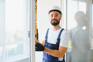 Young man repairing a terrace door