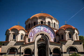 A large church stands beautifully under a blue sky overhead