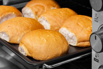 Bread rolls cobs cooked homemade in an elecric oven. Home baking concept