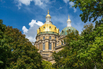 The Iowa state Capitol building on a hot late summer day with blue skies and clouds.  Des Moines,...