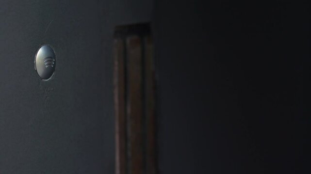 A child's hand opens a door using an electronic intercom key