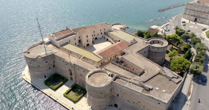 Aerial view of the Aragonese castle, officially called Castel San Angelo, in the historic center of Taranto, Puglia, Italy. It has a quadrangular plan and a large central courtyard.