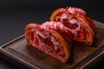Crispy fresh red croissant with cream and strawberries