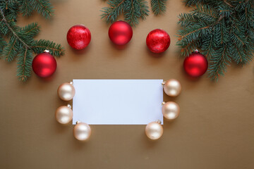Gold and red Christmas baubles on a gold background and christmas card.