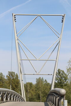 Modern white metal bridge over the river Ostravice

