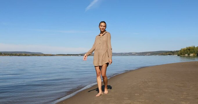 Photo posing - young beautiful girl shows correct poses for a photo on the beach