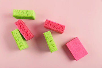 Cleaning set for different surfaces in kitchen, bathroom and other rooms on pink background. Cleaning concept, professional cleaning, household supplies. Top view, flat lay with copy space