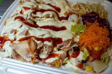 Delicious plate of chicken with creamy sauce, garnished with fresh vegetables. Perfect for food lovers looking for a hearty meal.