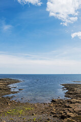Seascape with rocks, windfarm and copyspace