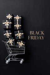 Black Friday shopping cart filled with black gift boxes tied with gold ribbons