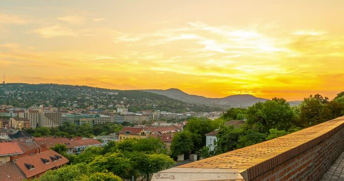 Budapest, Hungary - June 14, 2024: Sunset on Buda side, view from Arpad Toth Promenade. Time-lapse, zoom-out transition.
