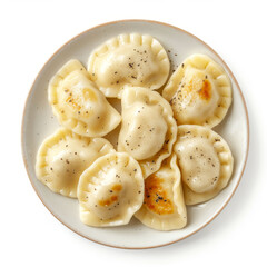 Top view of delicious homemade pierogi on a plate with visible seasoning