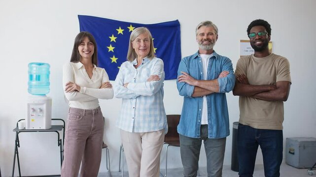 European mixed-raced people standing in row next to each other. Citizens spending time at office of European Union. Looking with joy at each other and crossing hands. Starting their working day.