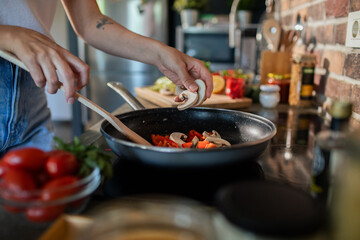 Young woman preparing fresh vegetables in a modern kitchen