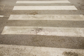 The texture of the road surface. Asphalt, marking of a pedestrian crossing