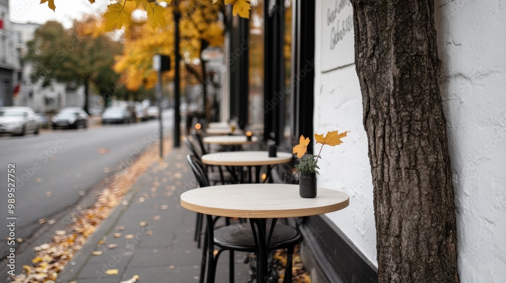 Canvas Prints A table and chairs on a sidewalk next to a tree