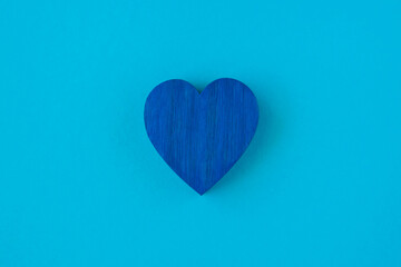 Blue wood heart on the blau background.