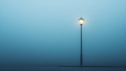 Single Street Lamp in Foggy Morning