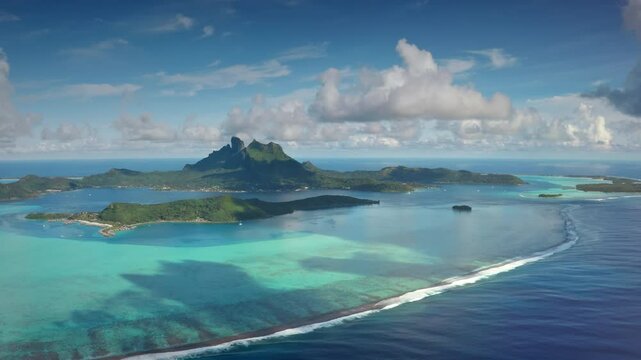 Aerial view Bora Bora island archipelago in French Polynesia. Turquoise lagoon coral reef barrier, mount Otemanu under blue sky. Remote wild nature paradise, exotic summer luxury travel. Drone flight