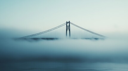 Obraz premium Suspension Bridge Emerging from Fog: A Misty Urban Landscape